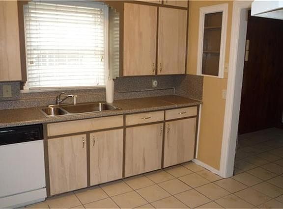 THIS KITCHEN ALSO HAS TILE FLOORS, DISHWASHER, AND A WINDOW OVER THE SINK FOR LOTS OF NATURAL LIGHT