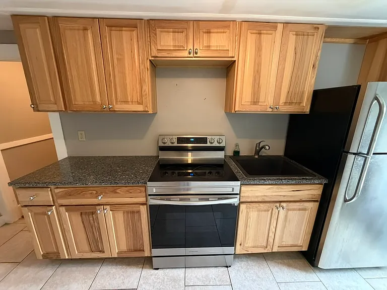 Kitchen has birch cabinets and stainless steel appliances