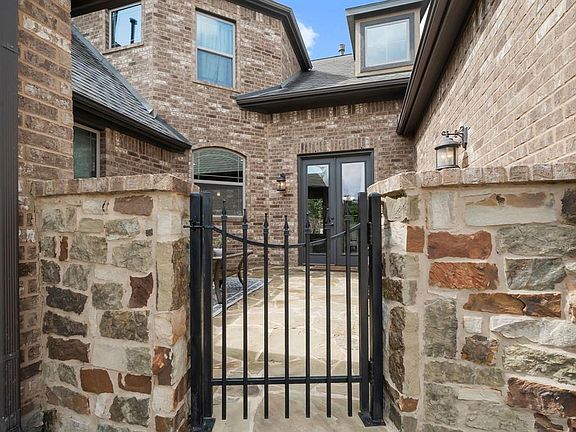 Charming courtyard with double doors opening into the breakfast room and kitchen area.