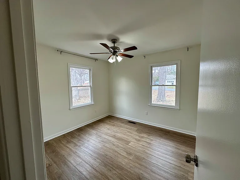 Bedroom #2 with view of the front and side yard. This bedroom is located at the end of the hallway and shares a wall with Bedroom #4.