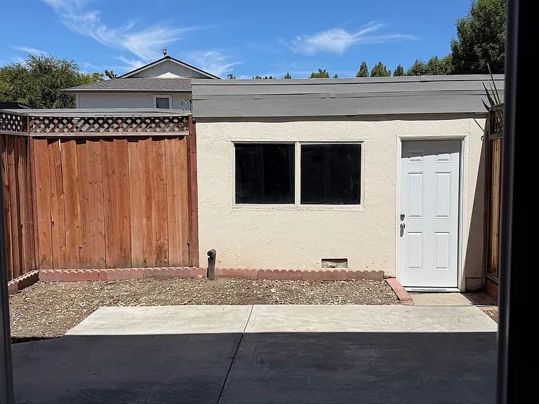 Backyard/patio view from kitchen with view of detached garage