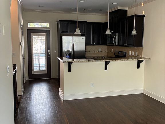 First floor. Kitchen + dining area. The door to the patio in in the back.