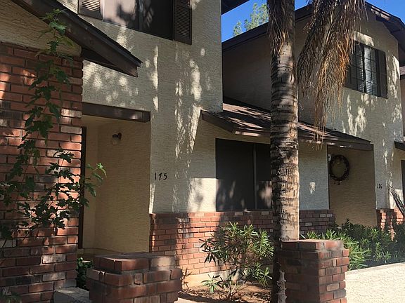 View of front of Townhome. Has sunscreens on all windows and has flower planter in front.