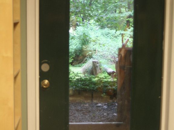 Entry door at ground level on south side of house