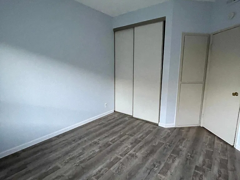 Bedroom 2: - Extra storage Cabinets behind the door.