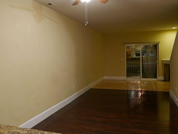 Dining room and living room combo with gas fireplace, patio door to balcony and half bath