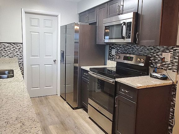 kitchen w granite and new fridge