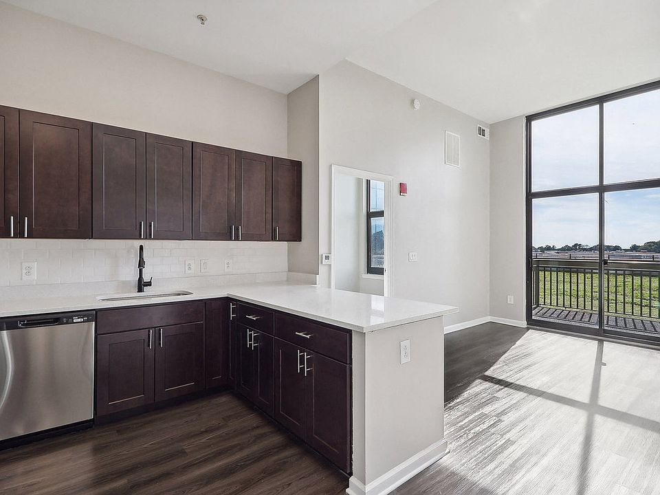 Kitchen with dark brown cabinets, stainless steel appliances and large window