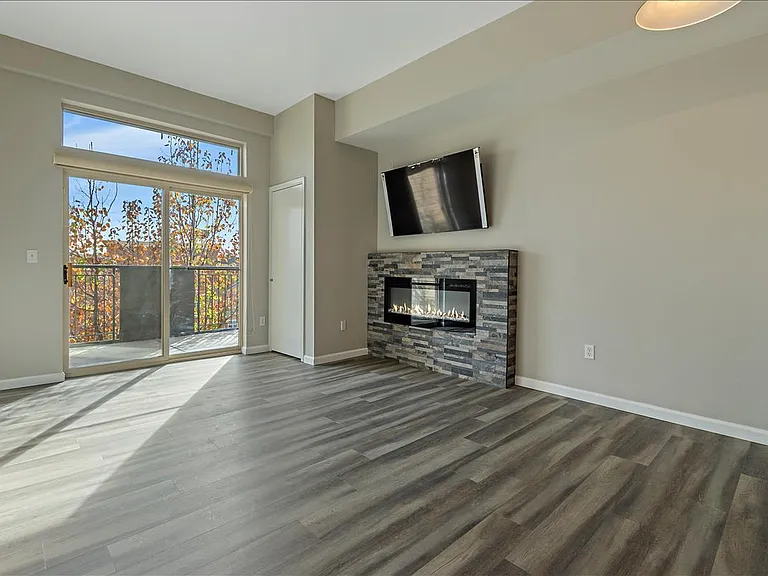 Spacious living room with a gas fireplace and flat screen TV