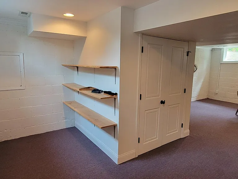 Enclosed furnace room for a cleaner esthetic. Seen on left, id the back of the removable panel over the laundry sink