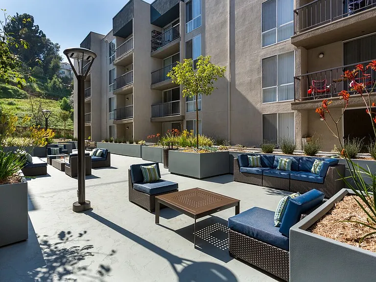 Resident courtyard with barbecue grills, fire pits, and lounge seating