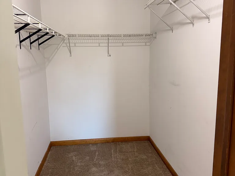 Walk in closet in primary bedroom