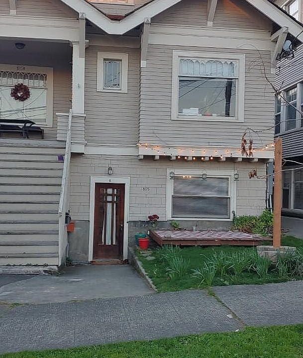 Exterior with entry, small yard & deck.
