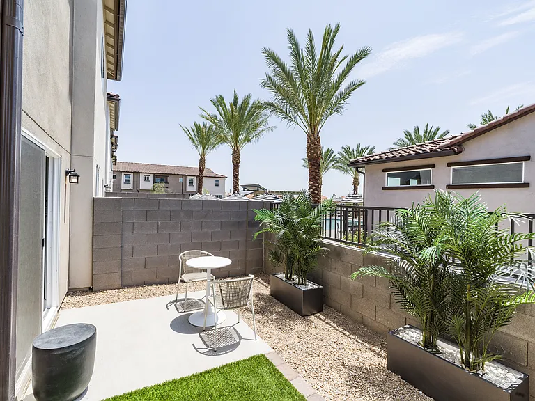 Embrace outdoor living at its finest at Amavi Aster Ridge with your very own fenced backyard featuring turf and a private patio.
