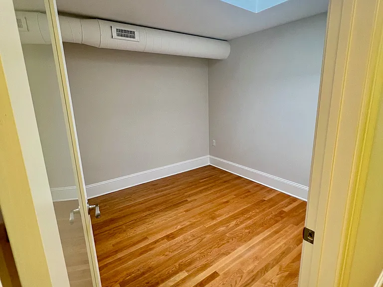 Bedroom 1 with historic skylight. Bright and airy.
