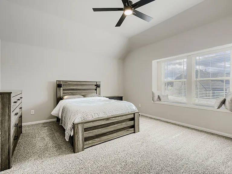 Bedroom featuring a vaulted ceiling and a built-in window seat