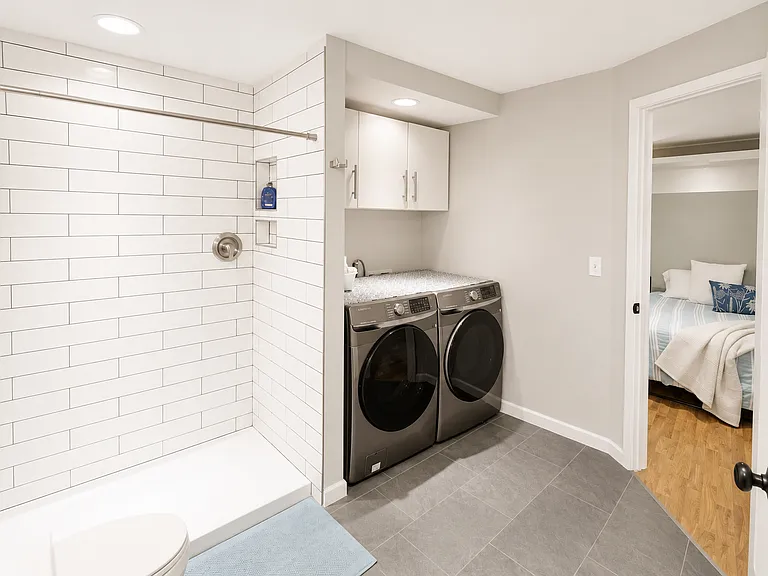Spacious Laundry Room with New Samsung Washer and Dryer - Third Bathroom with Large Tile Shower