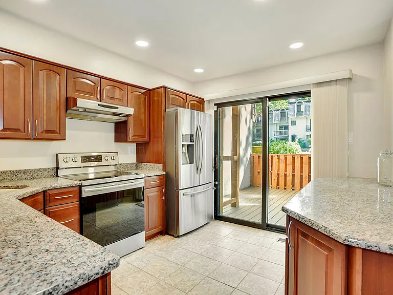 Kitchen with granite countertops and plenty of cabinets.