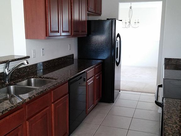 Kitchen (Full View) _ "Modern kitchen with stainless steel appliances and granite countertops."