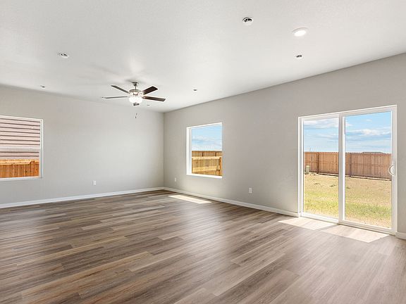 The family room is spacious with a ceiling fan.
