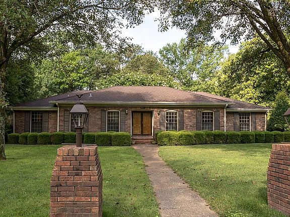 Mature trees surround home