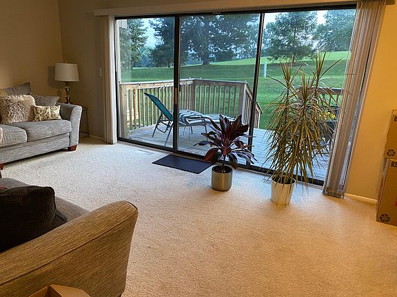Living room and deck looking out on golf course