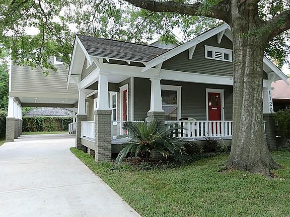 Professional landscaping, mature trees, an extensive concrete driveway and a porte-cochere complete 
