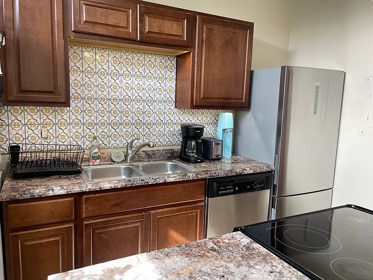 Kitchen with plenty of storage. Fully supplied with dishes, pots, pans, silverware. Double kitchen sink, refrigerator and freezer, oven with electric stovetop, dishwasher, coffeepot, soda stream, toaster (Microwave not shown). Washer and Dryer.