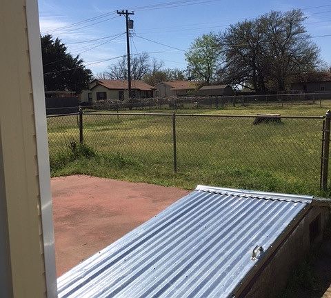 Storm cellar and fenced back yard