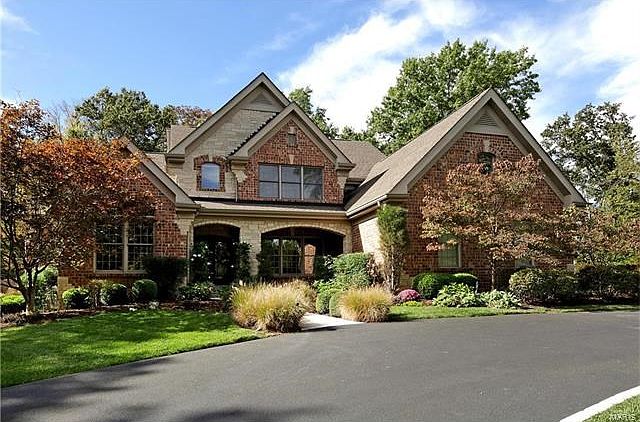 Gracious entry with flagstone walkway and covered front patio.