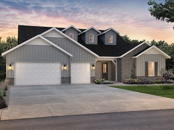 The classic Farmhouse elevation boasts stylish brick accents and window shutters for added curb appe