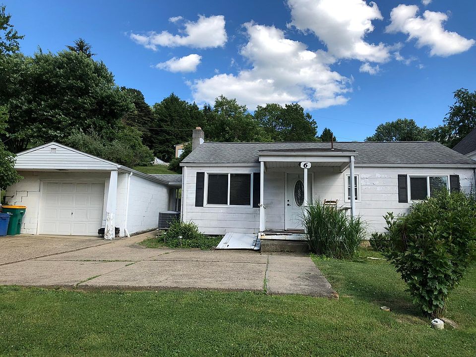 House snd garage with concrete driveway.