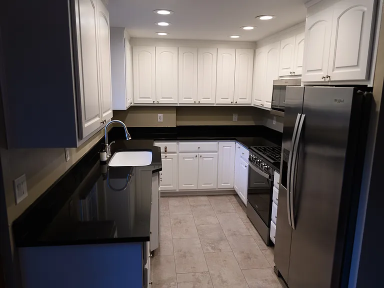 Kitchen with tons of cabinet space and a view of the back yard. The fridge, oven, microwave, dishwasher, and garbage disposal were all installed in the renovation.