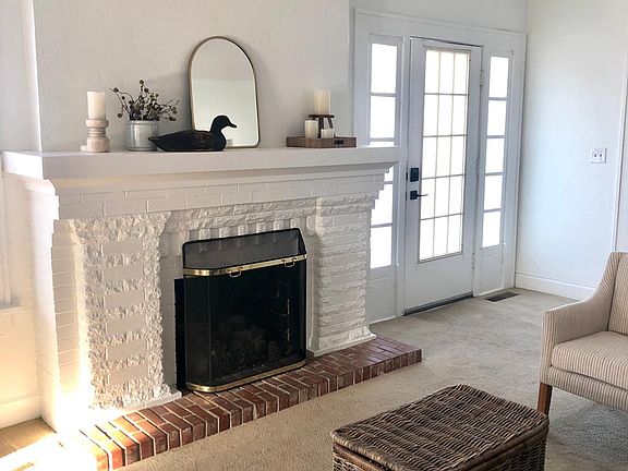Beautiful Arts & Crafts fireplace with 25-light frosted pane entry door for privacy.
