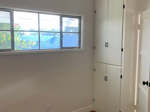 Inside bedroom looking out to front deck through window