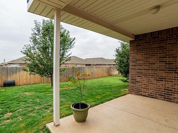 View of yard from covered patio.