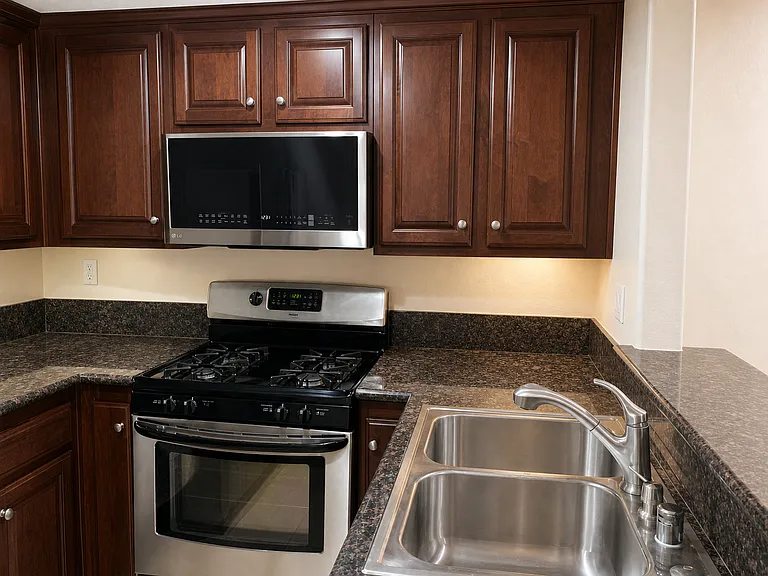 Kitchen - stainless steel fixtures and cherry wood cabinets