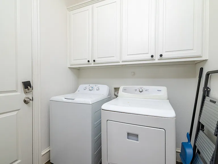 Convenient laundry room with full-size washer and dryer
