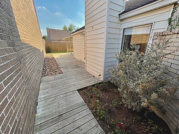 Woodend deck and walkway from left front of house to the backyard. Great for small plants or herb garden.