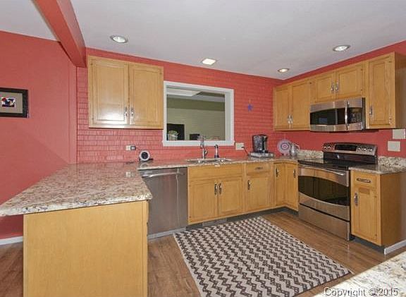 updated kitchen with granite counters and stainless steel applia