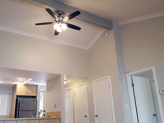 High vaulted ceilings with fans in living room and bedroom.