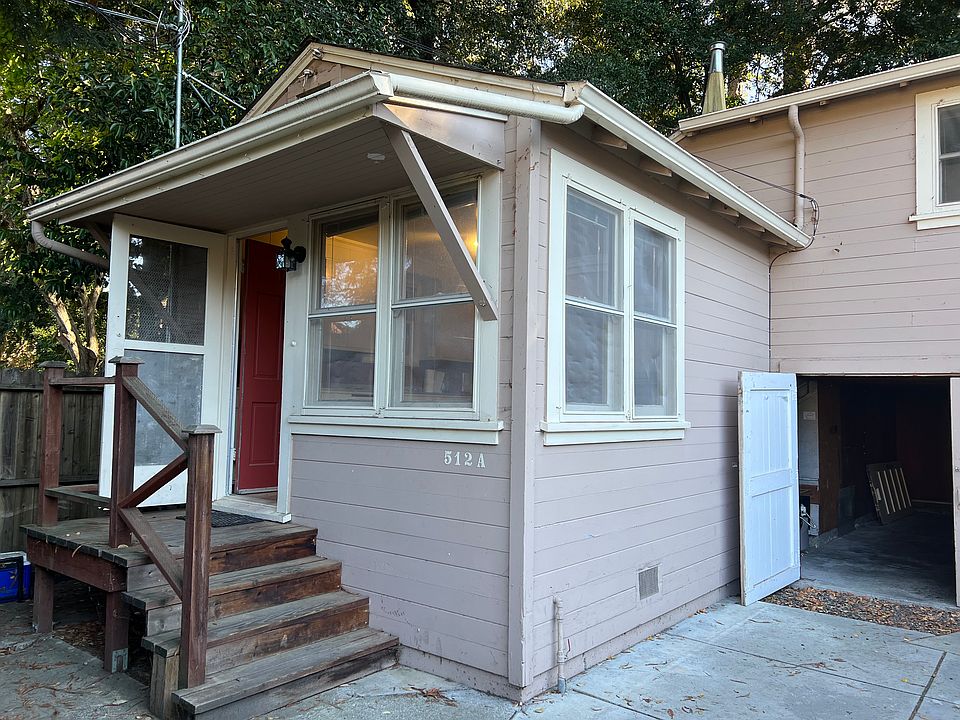 Front porch and view into the lower storage area where there are washer and dryer hookups