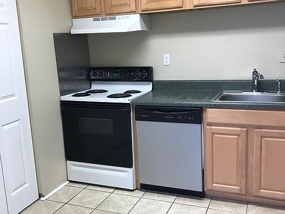 Kitchen is an L shape with plenty of storage. Laundry closet on left