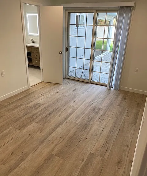 Primary bedroom with slider leading to backyard