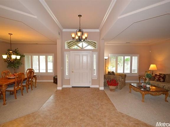 Elegant entry with tile flooring and formal living and formal dining on each side.