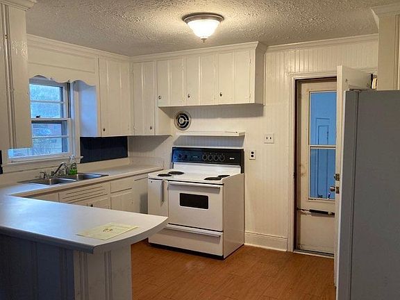 Kitchen with stove and refrigerator