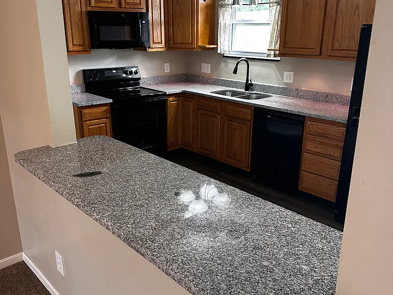 Semi-open design with bar-height granite countertop.