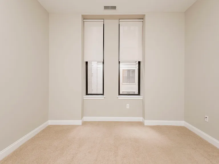 Victory Building Apartments bedroom with unique window details