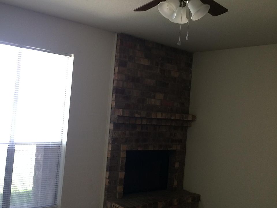 Living area with wood grain floor and fireplace