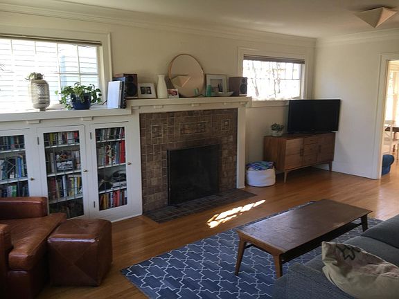 Living room with tile fireplace and built-in leaded glass cabinet